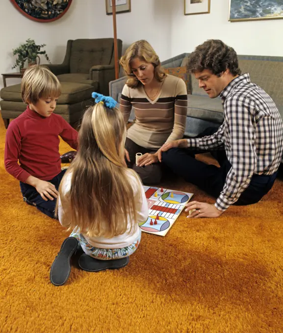 1970S Family Playing Parcheesi On Living Room Floor With Bright Orange Shag Carpeting