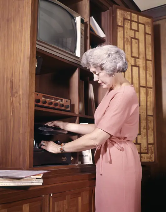 1970S Woman Playing Records Putting Record On Player