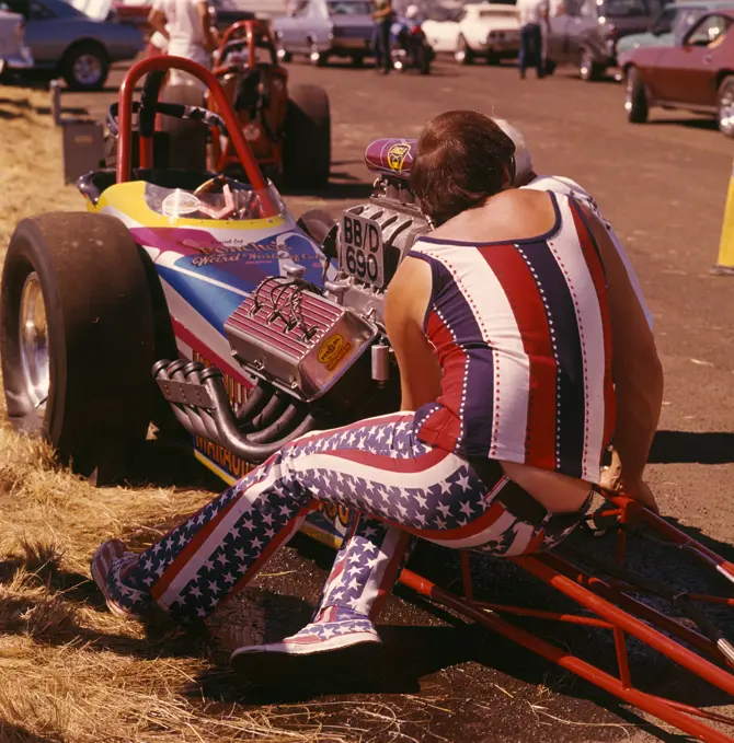 1960S 1970S Man Wearing Patriotic Clothes Working On Engine Of Drag Racing Car