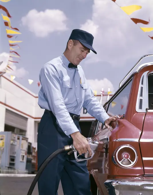 1950S 1960S Service Station Attendant With Gasoline Pump Hose Filling Gas Tank Of Automobile