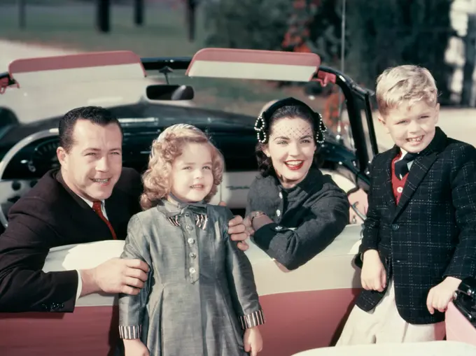 1950S Portrait Smiling Family Father Mother Son Daughter Sitting In Red White Convertible Automobile