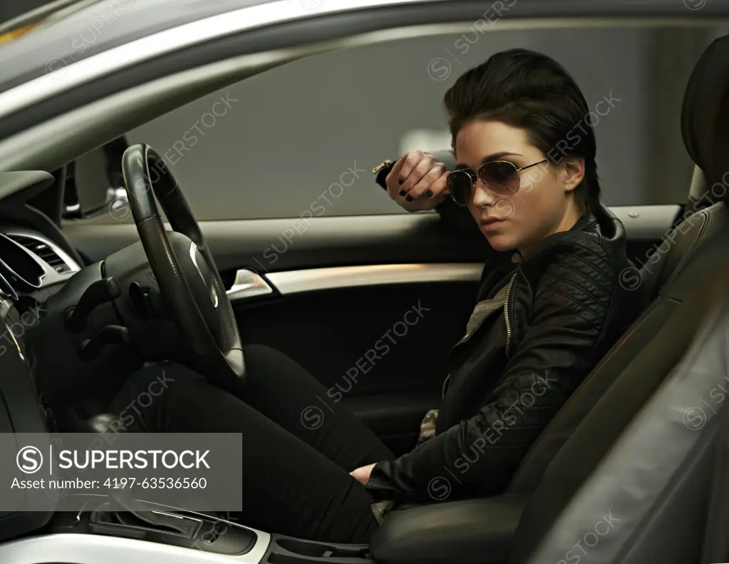 Woman, car and sunglasses while driving for a roadtrip commute in a stylish vehicle. Female person, vision and cool, fashion in a transportation motor for trip with confidence to travel destination