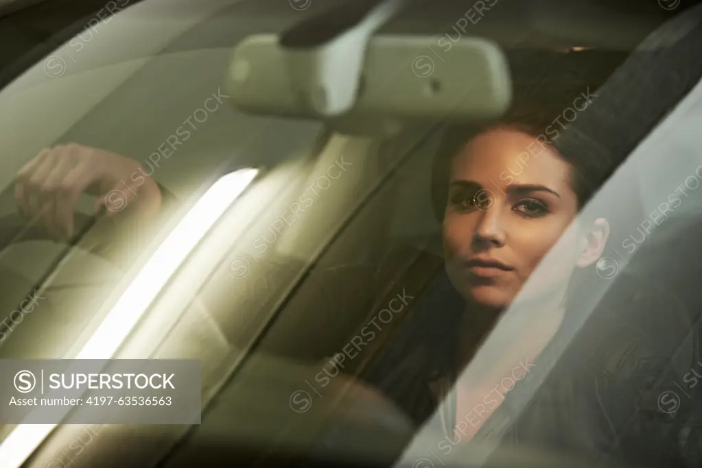 Woman, driver and look through windshield, portrait and car for transportation and night commute. Female, travel and vehicle pose for business, action and actress shot for commercial or movie scene