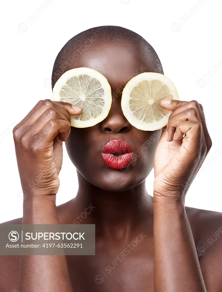 Black woman, kiss and lemon skincare in studio for organic dermatology routine, youth or wellness. White background, face and African model with facial fruit, diet food and eyes product for beauty