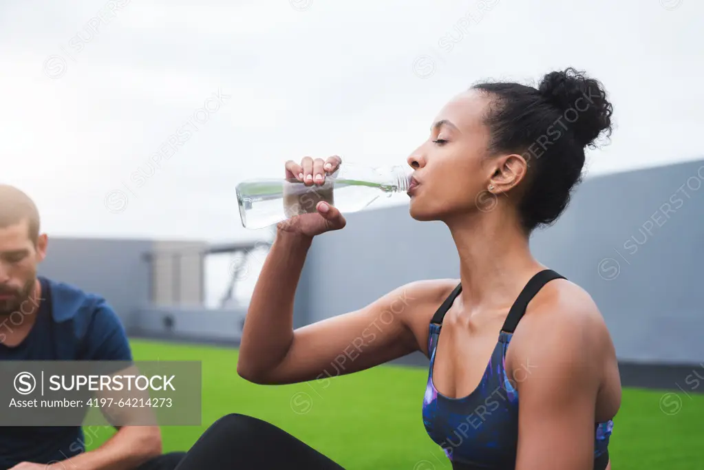 Couple, drinking water and woman with fitness, relax and nutrition with wellness, healthy and aqua. People, outdoor and athlete with liquid, bottle and balance diet with workout, training or exercise