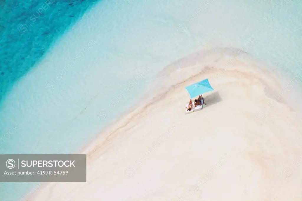 shot from jet of two people sunbathing on paradise beach