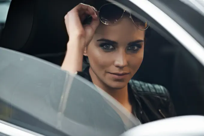 Woman, car and portrait while driving for a roadtrip commute in a luxury vehicle. Female person, face and window of a transportation motor for trip with confidence to travel destination