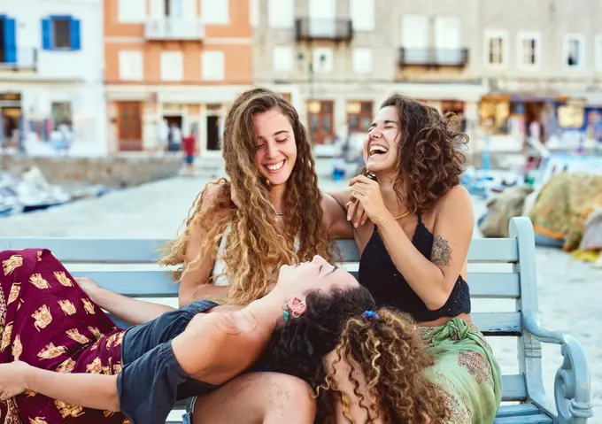 Happy, conversation and women in city for holiday, summer vacation and adventure together. Laughing, travel and friends talking, chatting and relax for journey, bonding and tourism in Barcelona