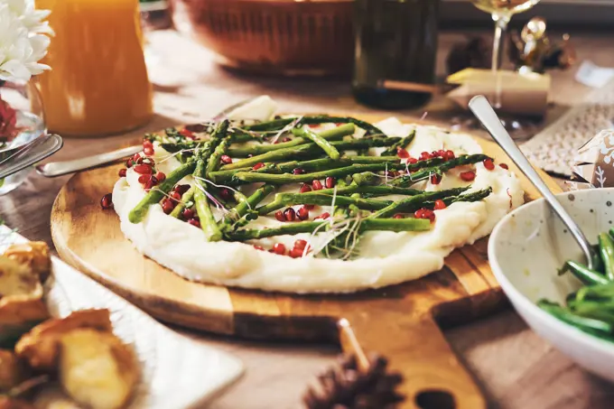 Food, thanksgiving dinner and dish in home on table with asparagus for health, wellness and diet meal. Vegetables, feast and festive cuisine for lunch, brunch or supper at party or event at house.