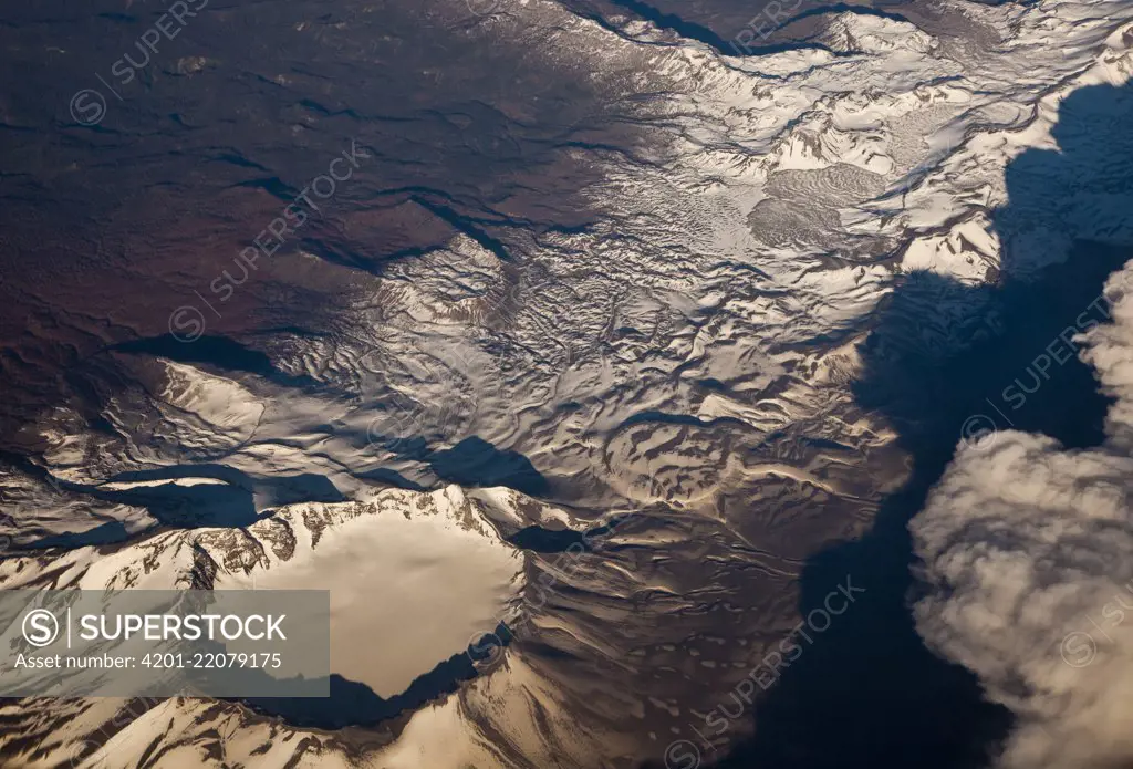 Snow-covered volcano showing caldera, Andes, Chile