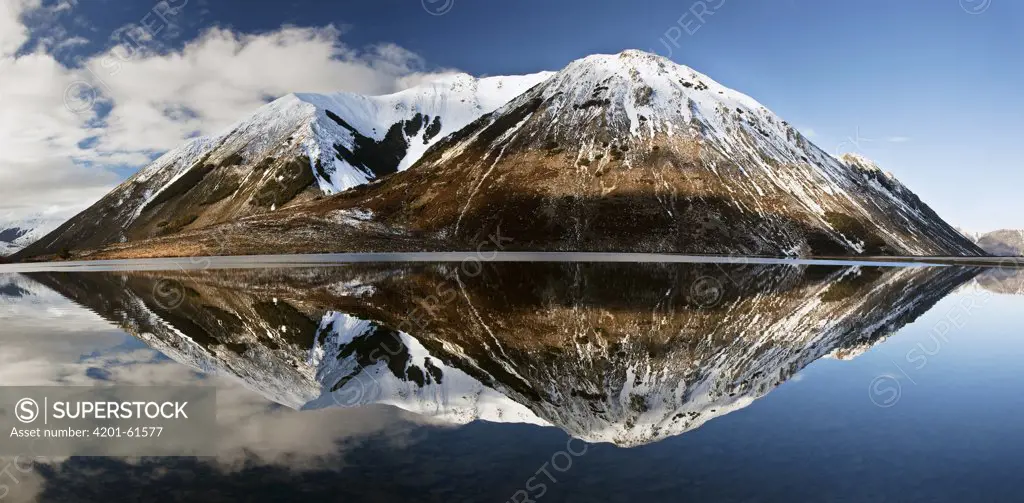 Mountains reflecting in Lake Pearson in winter, Castle Hill Basin, Canterbury, New Zealand