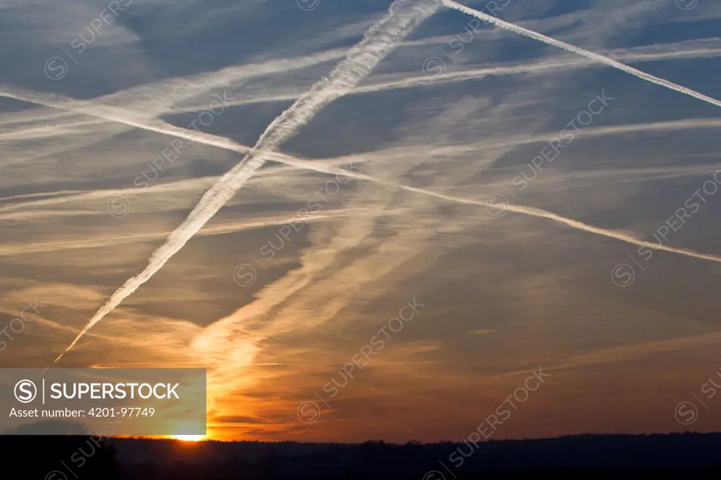 Vapor trails from airplanes at sunset, Germany