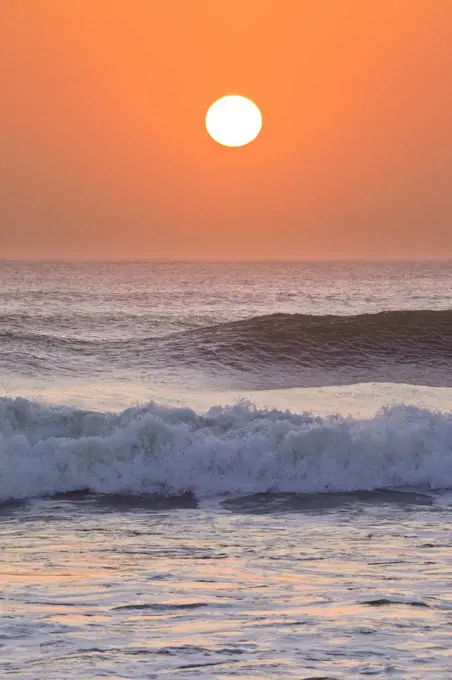 Sun setting over ocean, Cape Cross, Namibia