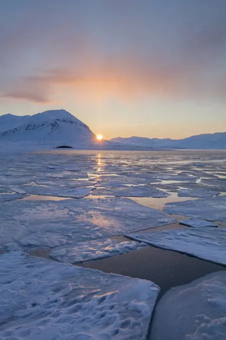 Midnight sun over ice floes in late winter, Svalbard, Spitsbergen, Norway