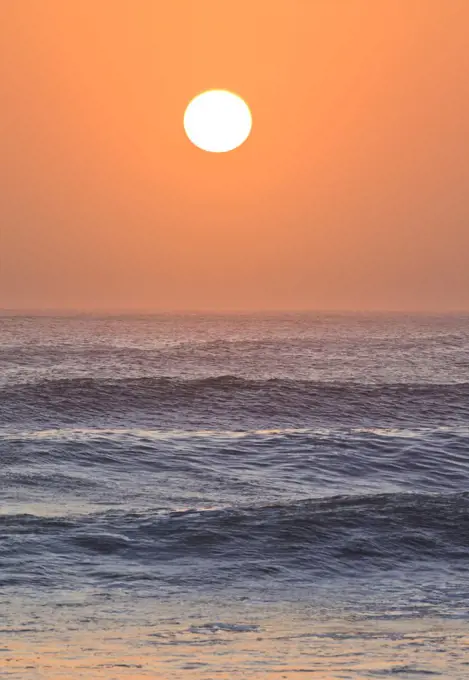 Sun setting over ocean, Cape Cross, Namibia