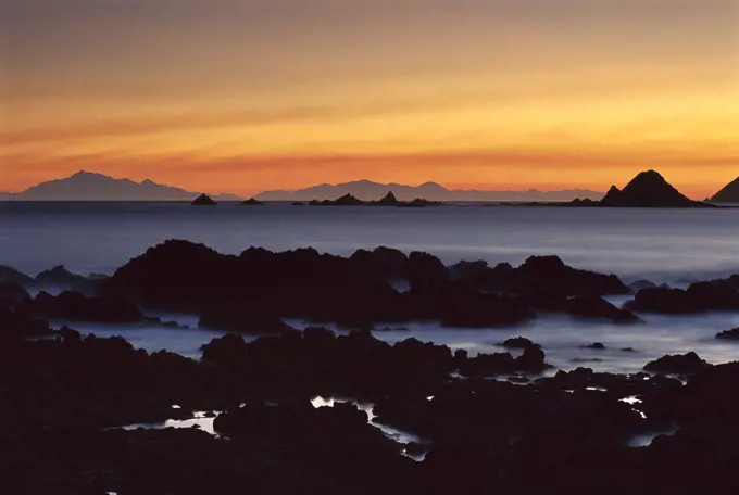 South Island seen from Island Bay at sunset, Wellington, New Zealand