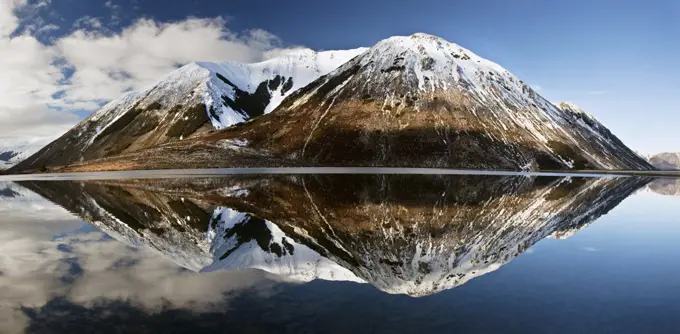 Mountains reflecting in Lake Pearson in winter, Castle Hill Basin, Canterbury, New Zealand