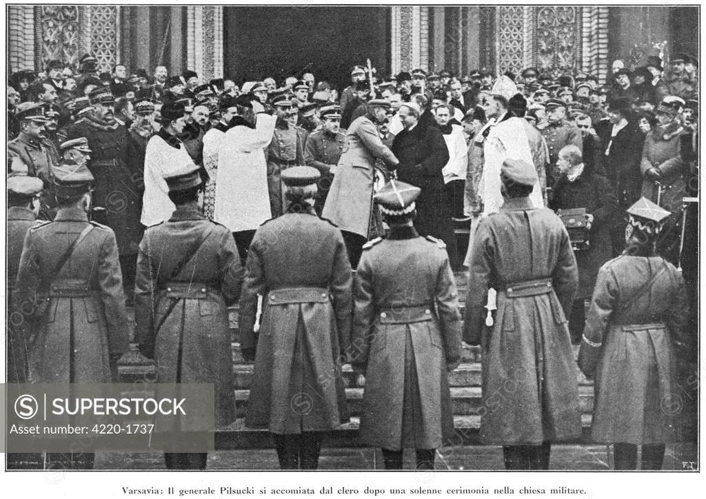 Marshal Jozef Piludski takes  his leave of the clergy after  a religious ceremony affirming  the unity of his military  government with the church.