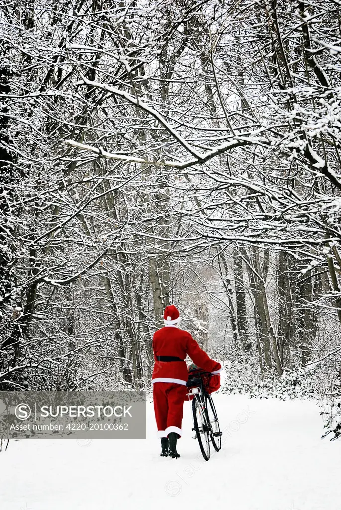 Father Christmas - in snow - with bicycle  