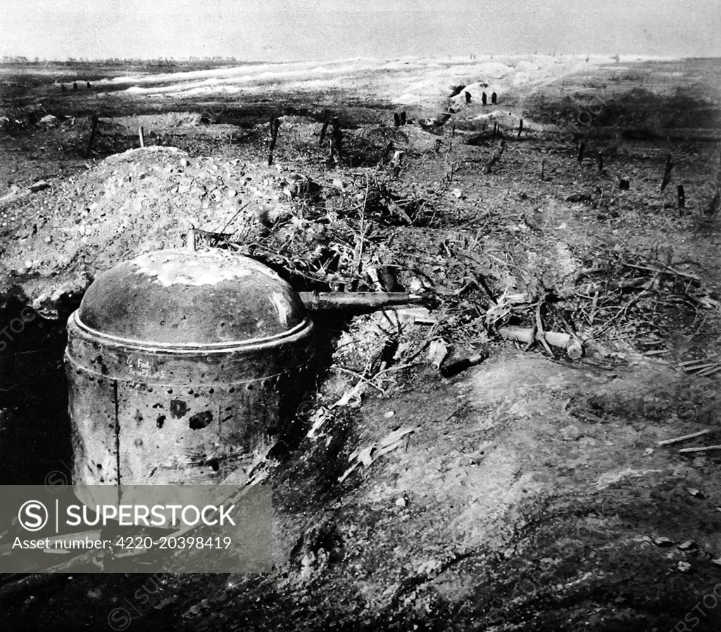 A revolving German gun-turret, revealed after constant bombardment of its trench by the French in September 1915.  The turret had a quick-firing gun served by three men, who were locked inside.  Before bombardment, only the domed top was visible above ground.     Date: October 30th 1915