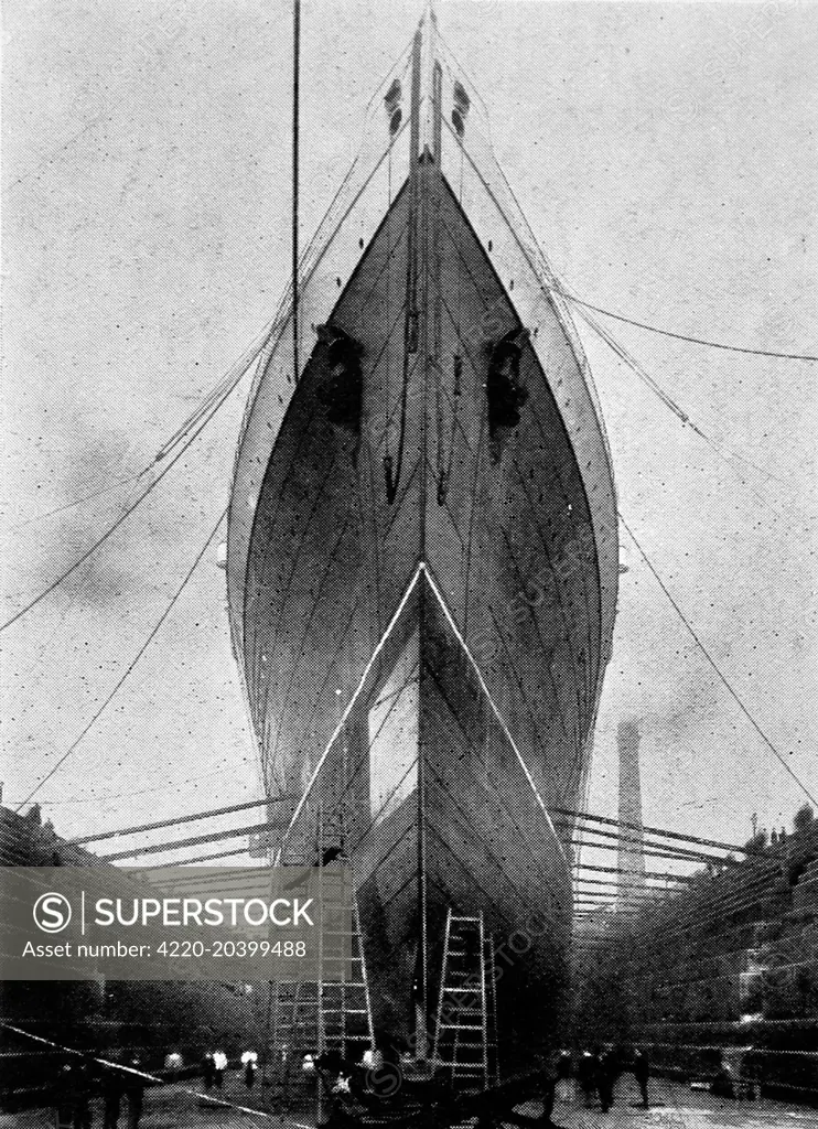 Photograph of the bows of the Cunard Liner, SS 'Lusitania', in dry dock 1907.  'Lusitania' was then the largest liner afloat, weighing 32,500 tons and capable of twenty-six knots.     Date: 1907