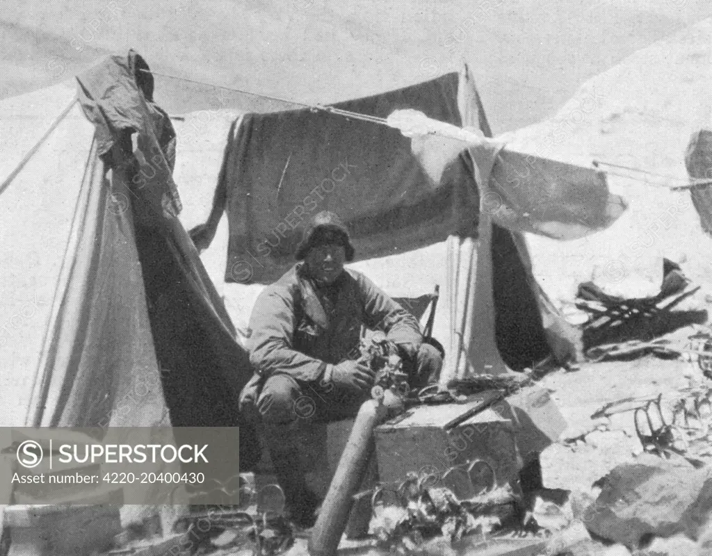 Photograph of Andrew Comyn Irvine (1902-24), the British climber, working on an oxygen bottle in the Everest Expedition camp, 1924.    Irvine, although a relatively inexperienced climber, was an expert in the maintainence and repair of oxygen tanks and it was for this skill that he was chosen to accompany George Leigh Mallory for their fatal attempt on Everest.     Date: 1924