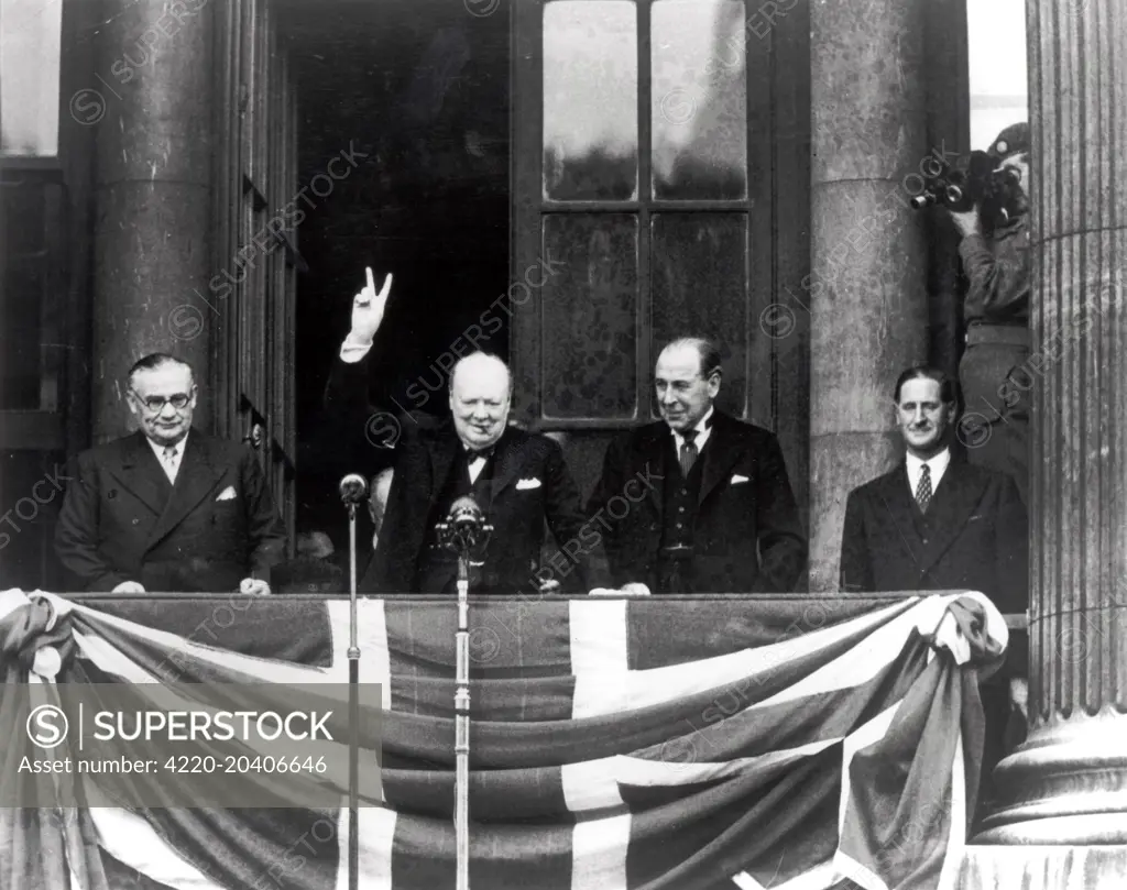 The photograph shows Winston Churchill and Ernest Bevin on the balcony of Buckingham Palace on VE Day.     Date: 8th May 1945