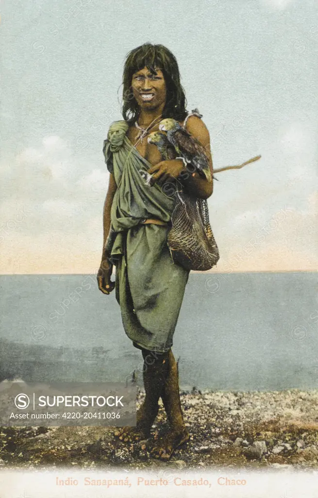 A Sanapana youth with string bag and holding two parakeets. The