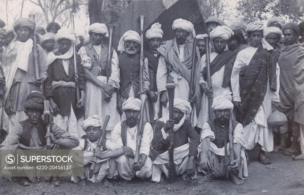 Pathan Tribesmen - North West Frontier Province. On the reverse of this postcard, a British officer has written &quot;These are the hillmen we have to contend with&quot;! Spot the cheeky British soldier sneaking into the shot...     Date: circa 1920s