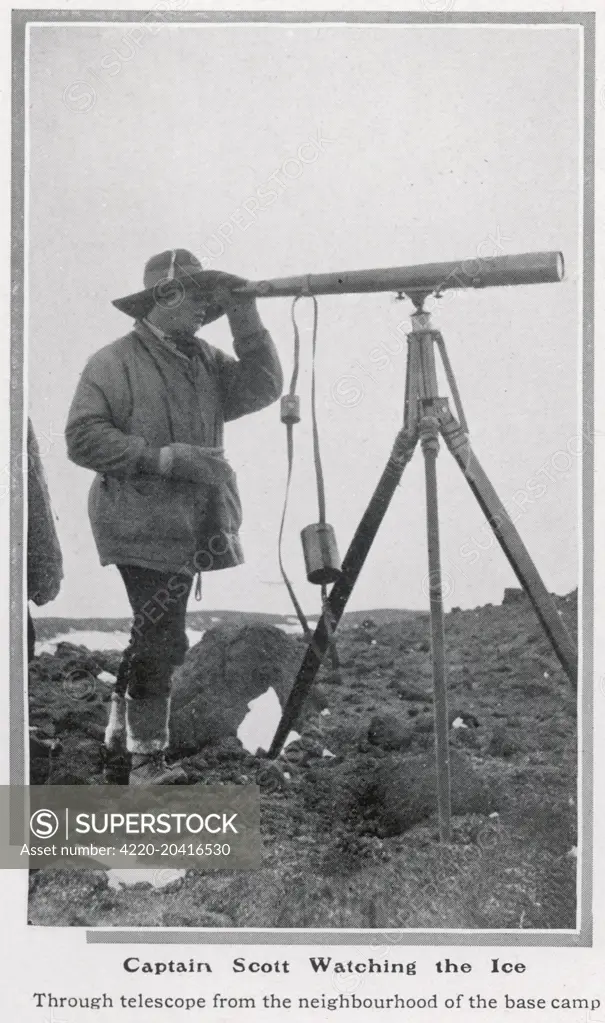 Captain Robert Falcon Scott (1868 - 1912), British polar explorer pictured watching the ice through a telescope at base camp during his ill-fated Antarctic expedition.  1913