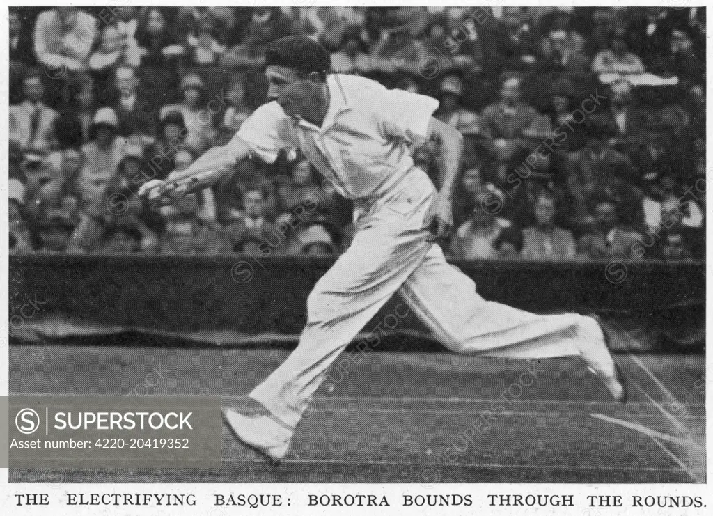 Jean Borotra (1898-1994), French tennis player known as the 'Bounding Basque' (although the Illustrated Sporting and Dramatic News describes him here as the 'electrifying Basque'), pictured here in action during a match at Wimbledon in 1929 wearing his signature beret.     Date: 1929