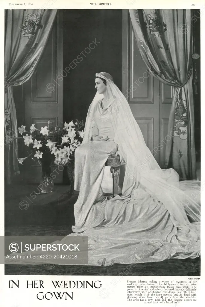 Princess Marina of Greece looking a vision of loveliness in her wedding dress designed by Captain Edward Molyneux in a photograph taken at Buckingham Palace the week before her wedding to Prince George, Duke of Kent at Westminster Abbey on 29 November 1934.  The gown was of white and silver flowered brocade delicately interwoven with an English rose design; and the Court train, of the same material and lined with silver lame, fell 4 and a 1/2 yards from the shoulder.  The dress had a cowl neck a