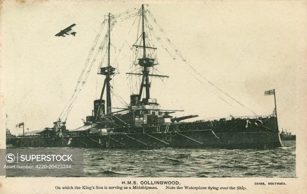 The HMS Collingwood with a seaplane flying overhead. A St Vincent Class Dreadnought Battleship, launched in 1908, commissioned in 1910 and scrapped in 1922. Prince Albert, later King George VI served onboard HMS Collingwood as a midshipman.     Date: circa 1911