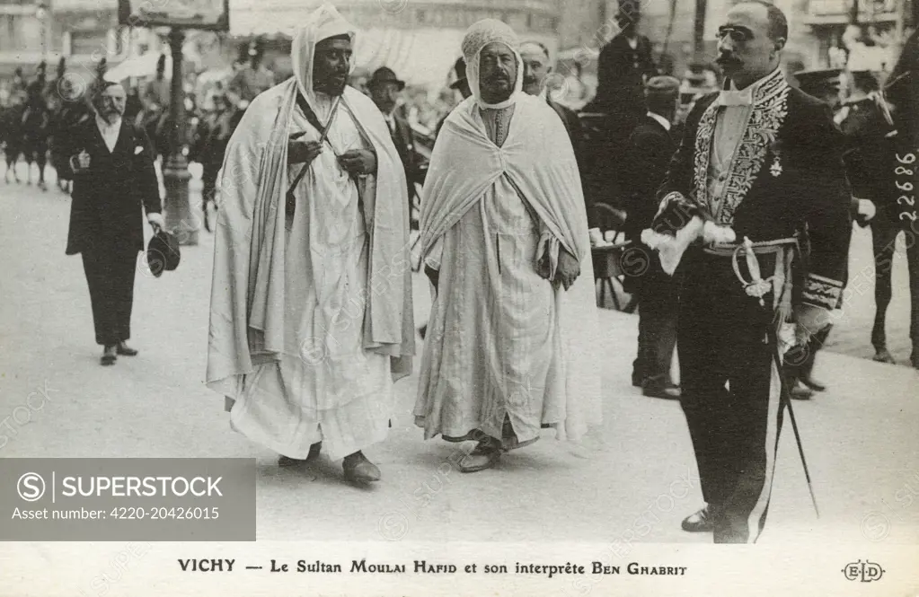 Abdelhafid of Morocco (Mulay Abdelhafid) - The Sultan of Morocco, (1876-1937) and his Interpreter Ben Ghabrit at Vichy, France following his abdication in 1912 after signing the Treaty of Fez, (which made Morocco a French protectorate). On return to Morocco he was exiled to the Dar el Makzhen (Sultanate Palace) in Tangiers.     Date: 1912