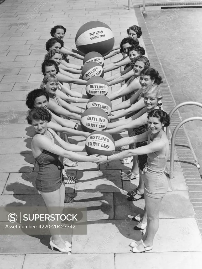 A group of young women in swimsuits with beach balls at Butlins holiday camp in Skegness.   