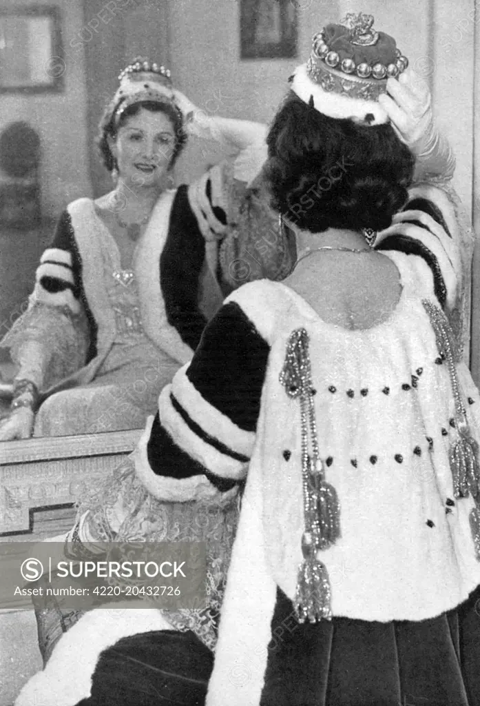 The robes of a viscountess for the Coronation of King George VI in 1937, tried on at one of the Court tailors.  The cape has 2 1/2 bars of miniver and the coronet has sixteen silver balls, which had to be fitted on behind a tiara.     Date: 1937