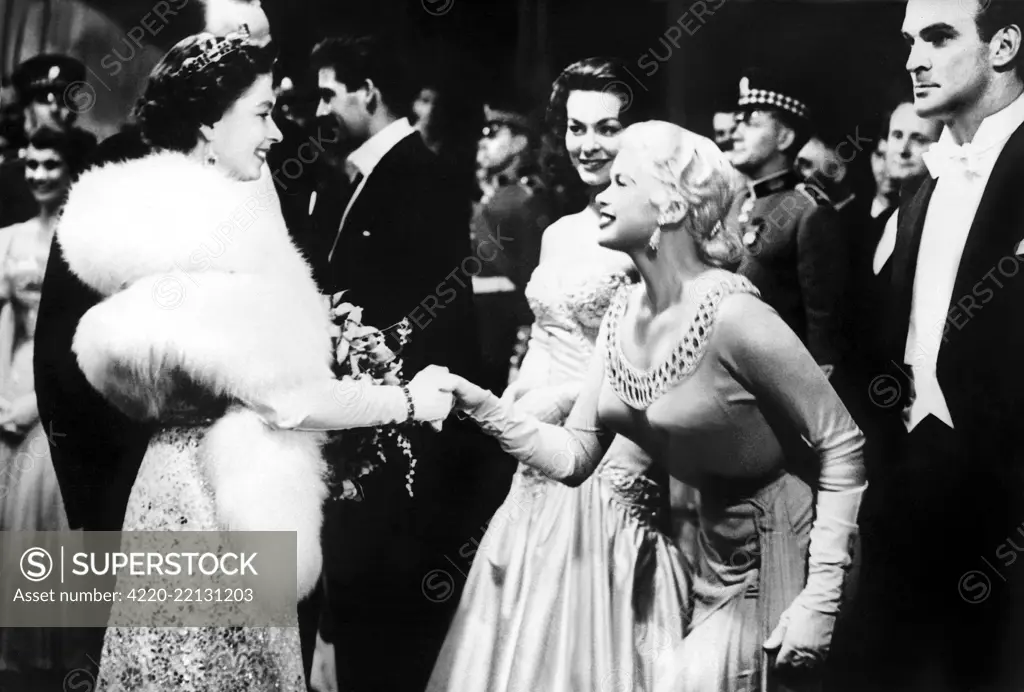 Queen Elizabeth II, Jayne Mansfield (American actress) &amp; Stanley Baker (British actor) at a Royal Film Performance and premiere in London.  6 November 1957