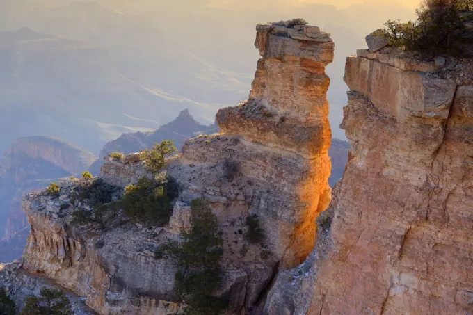 Grand Canyon - rock formation in the shape of a turret and panoramic view from Yaki Point into the Grand Canyon at sunrise. Grand Canyon National Park - South Rim - Arizona - USA .