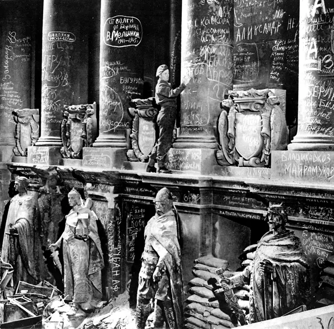 Photograph showing a British soldier adding a message to the walls of the German Reichstag, shortly after the end of the Second World War in Europe, July 1945.    Most of the graffiti visible in this picture was created by the victorious Russian soldiers after they had crushed the last Nazi resistance in Berlin.     Date: 14/07/1945