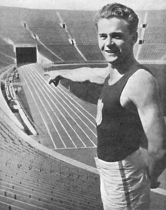 Frank Clifford Wyckoff (1909 1980) was an American athlete and triple gold medal winner in 4x100 m relay at the Olympic Games in 1924, 1928 and 1932.  Pictured here pointing to the scene of the 'Olympic pageant'.         Date: 1932