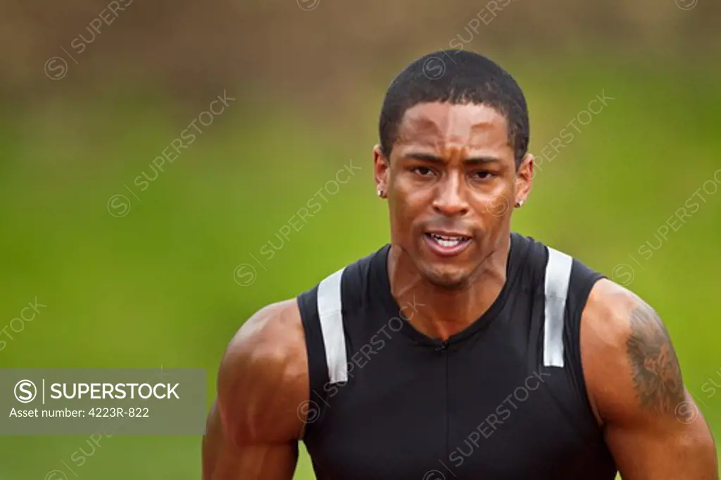 Male sprinter in blocks, awaiting starting gun