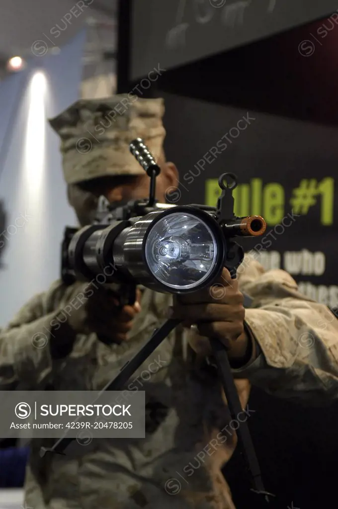 A marine tests the Night Hunter II, a rifle mountable flashlight at the Marine Corps Instillations West Expo. The NHII can be used to see objects 1200 meters away with white light and 800 meters away with infrared attachment. The light weighs four and a half pounds over half the weight of an M16-A2.                     