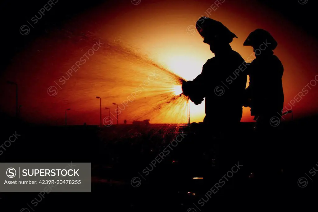 Operation Enduring Freedom - Airmen run an operations check on a fire hydrant hose on Al Udeid Air Base, Qatar.  