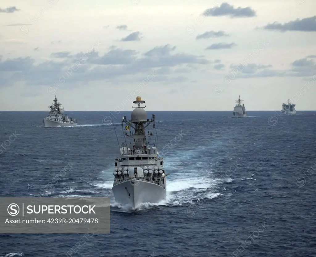 Bay of Bengal, April 14, 2012 - The Indian Navy guided-missile corvette INS Kulish (P63) leads the Nimitz-class aircraft carrier USS Carl Vinson (CVN 70), the Ticonderoga-class guided-missile cruiser USS Bunker Hill (CG 52), and the Arleigh Burke-class guided-missile destroyer USS Halsey (DDG 97) while underway in formation with Indian Navy ships during Exercise Malabar 2012. 