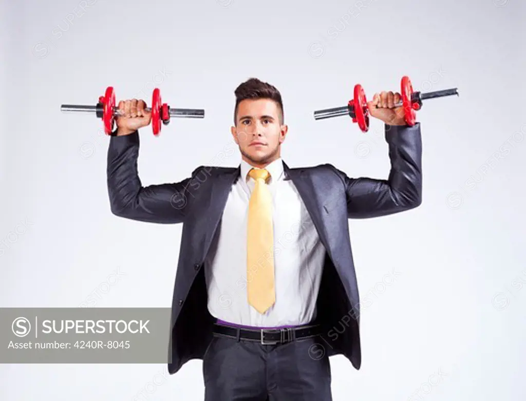 Strong Businessman Lifting Heavy Weights