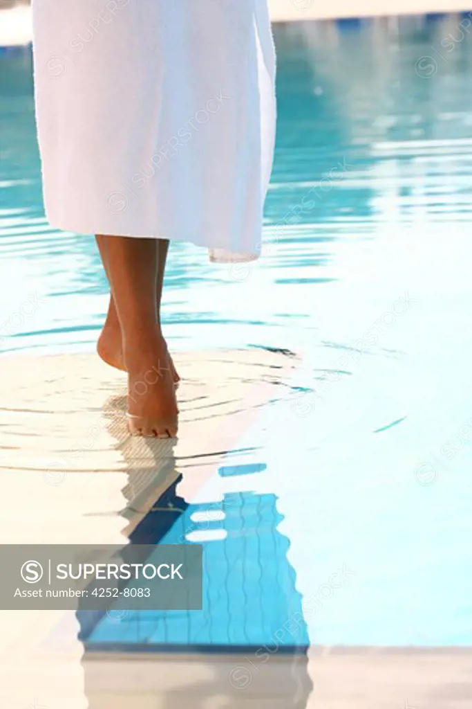 Woman feet and swimming pool