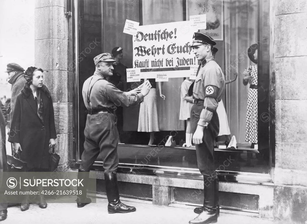 SA and SS men post signs signs reading "Germans! Defend Yourselves! Don't buy from Jews!" Berlin, April 1, 1933, Anonymous  