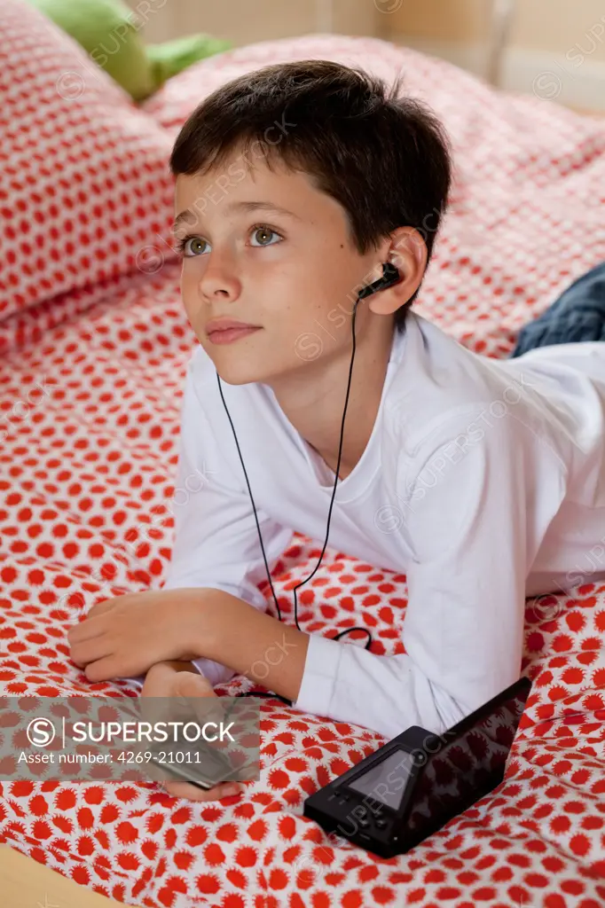 Boy listening to music on an iPod MP3 player.
