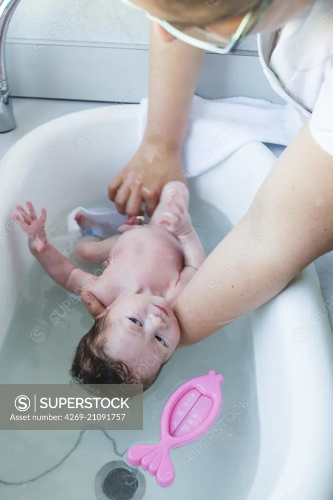 Premature newborn baby having his first bath, CHU Bordeaux, France.