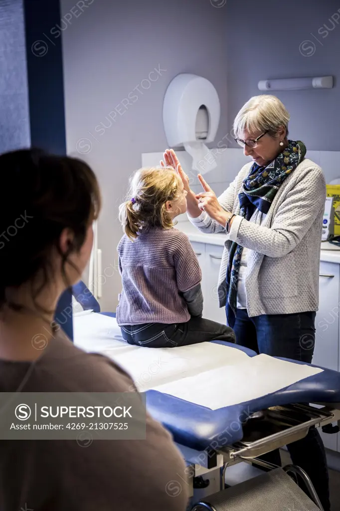 General practitioner with child, Geveze, France.